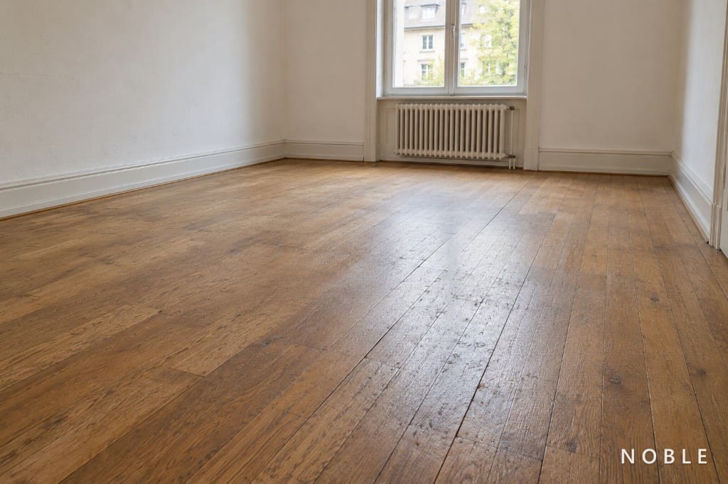 Worn parquet floor before renovation